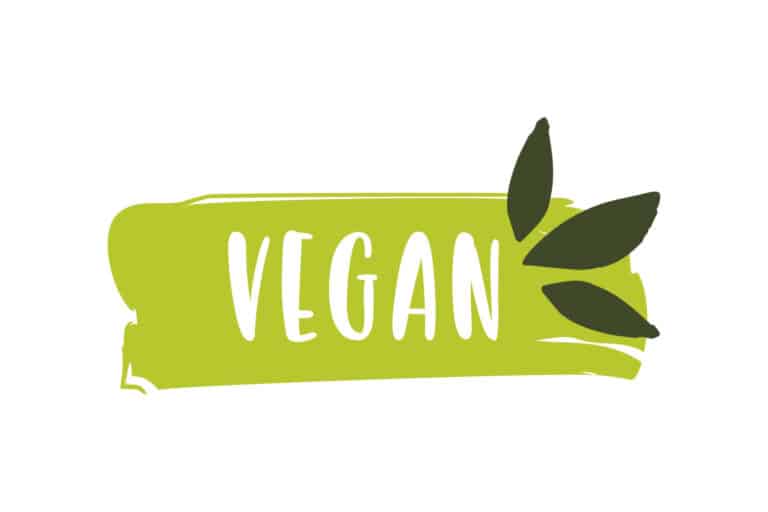 Vegan in white text on a green background with three green leaf illustrations on the right hand side of the word